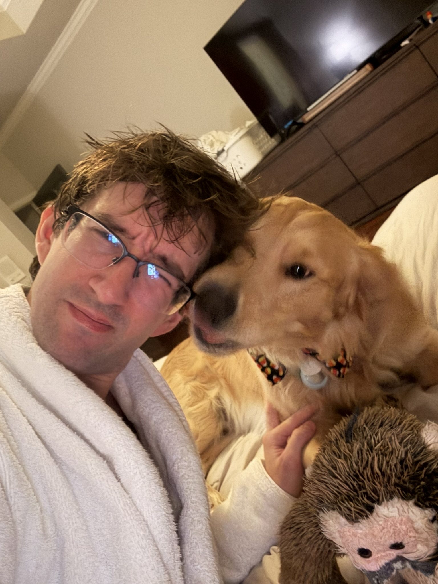 Winnie pressing his face close to his dad during a selfie.